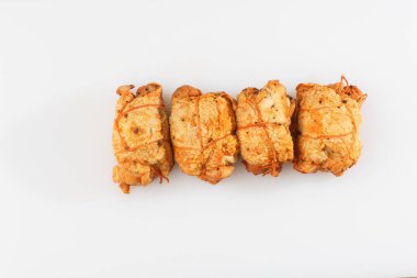 Ahşap arka planda izole edilmiş marul yaprağı desenli ızgara tavuklu rulo. Taze et ve kısmen dilimlenmiş. Tavuklu jambon ve lezzetli tavuk eti. Organik çiftlikten doğal ürün..
