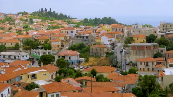 Village in the mountains. Greek old city, down town. Travelling Europe. Top view of white houses with red roofs in Greek city Kymi on Evia, Euboea island, Greece. Beautiful cityscape view — Stock Video