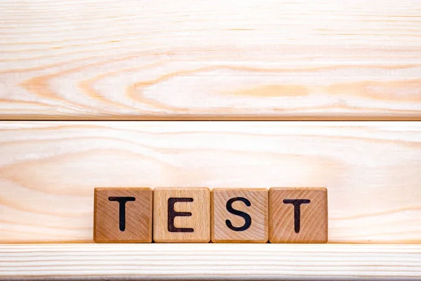 Test word concept. The word Test on wooden cubes. Test as steps to progress our business, life. Test to control our health. Test background. — Stockfoto