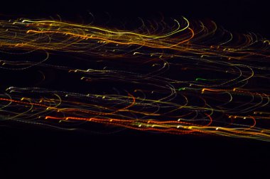 Blurred Defocused Lights of Heavy Traffic on black night background. Lines of lights. Abstract background. City life backdrop. City lines of lights at night. Technology backgroud