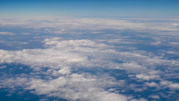 Traveling by air above clouds. View through an airplane window. Flying over the Mediterranean Sea through cirrus and cumulus clouds and little turbulence, showing Earths atmosphere — Stock Video