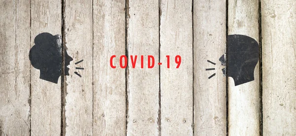 Coronavirus COVID-19. Protect vulnerable adults and older people. Head, people, listen and speak icon, flat design. Part of a series. Man and woman conversation icon illustration on wooden background — Stock fotografie