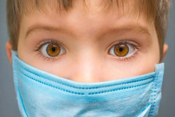 Boy in medical mask. Kid with closed eyes. Coronavirus COVID-19 lockdown, panic. Vaccine from new virus. Hiding from problems. Psychology, pediatric background. Child and injection. Negative emotions