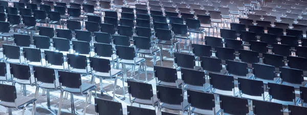 Empty seats. Equipped conference hall. Indoor business conference. Interior of a congress hall. Cancelled meetings, lectures, lessons, forums due to global disease. Online event. Web conference.