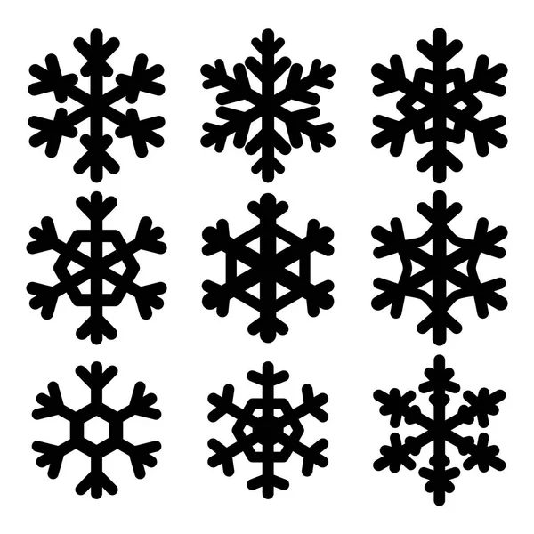 Conjunto de flocos de neve pretos. Silhuetas isoladas sobre fundo branco — Vetor de Stock