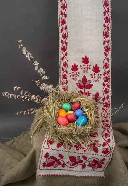 Easter eggs in a nest on an embroidered towel