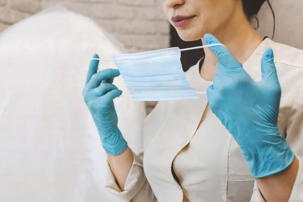 female doctor putting on face mask