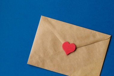 Aziz Valentine 'in aşk mektubu. Klasik mavi arka planda kırmızı kalpli el işi kağıdı. Yatay olarak. Renk 2020.