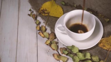 Cup of coffee with coffee beans on vintage wooden table. Homemade coffee or americano. Coffee break
