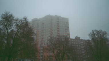 Sabahları sisli arka planda modern apartman binaları. Modern bir konut binasının ön cephesi. Modern apartman binası mimarisi