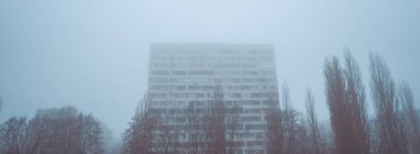 Sabahları sisli arka planda modern apartman binaları. Modern bir konut binasının ön cephesi. Modern apartman binası mimarisi