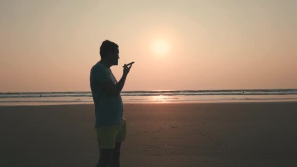 Young Man Using Smartphone Beach — Stock Video