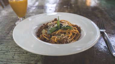 Kafe masasında nefis bir makarna. Bir porsiyon lezzetli makarna ve kıyma ile yakın plan bir restoranda masaya koyun