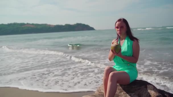 Beautiful Young Woman Sitting Log Drinking Coconut Sea Ocean Bright — Stock Video