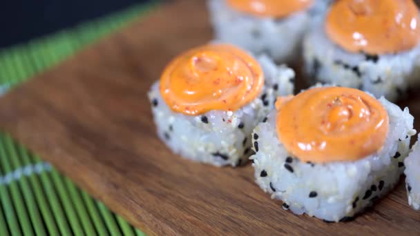 Manger des rouleaux de sushi avec des baguettes. Nourriture japonaise au restaurant. Femme tient des sushis avec des baguettes. Concept des aliments japonais . — Video