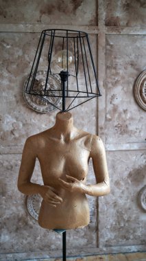 Dekoratif duvarın arka planında masa lambası olan mankeni kapat. Oda dekorasyonu için ev yapımı olağandışı yaratıcılık.