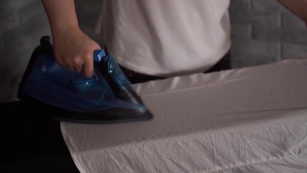 Woman ironing clothes on ironing board, close-up — Stock Video