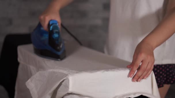 Woman ironing clothes on ironing board, close-up — Stock Video