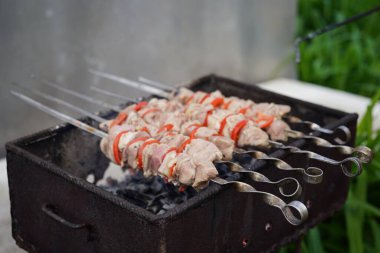Şişler üzerindeki çiğ şiş kebabı kapat. Izgarada kızaran sulu barbekü..