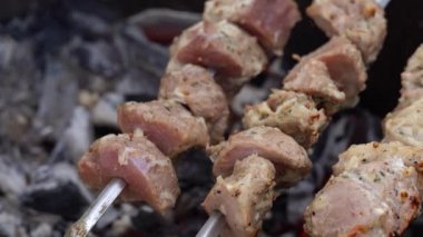 Şişler üzerindeki çiğ şiş kebabı kapat. Izgarada kızaran sulu barbekü..