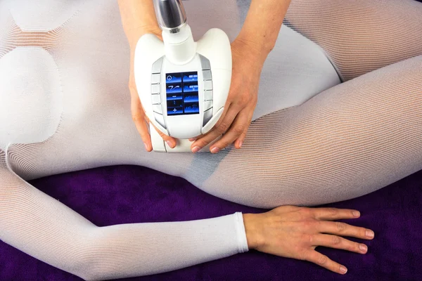 Female body in a white suit having anti cellulite massage — Stock Photo, Image