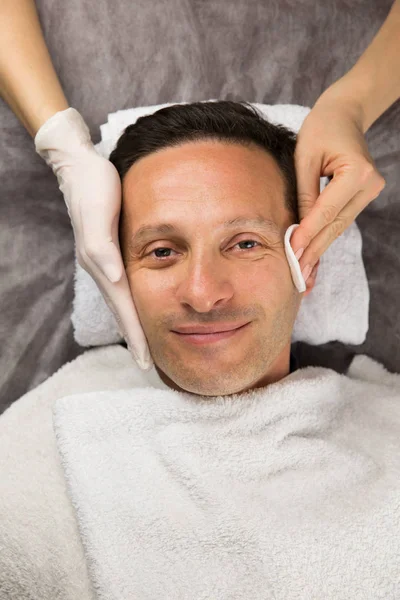 Male face, hands of professional beautician with gloves — Stock Photo, Image