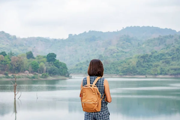 Women shoulder backpack Background mountains and water at Wang Bon dam Nakhon nayok , Thailand