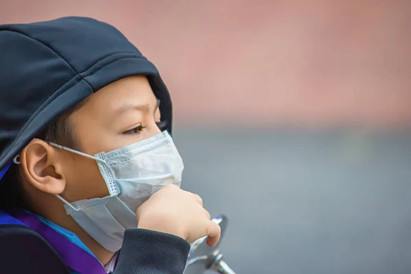 Asean Boys wear a mask to prevent dust in Bangkok ,Thailand.