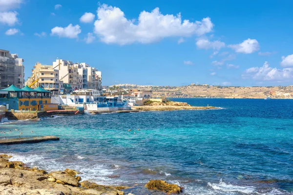 Stone shore and seaside buildings — Stock Photo, Image