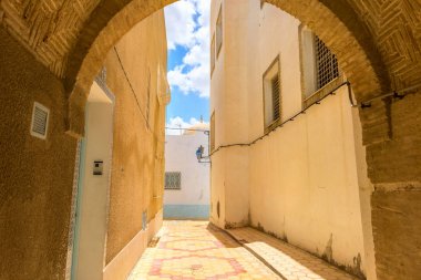 Cityscape with narrow street in Medina of Kairouan. Tunisia, North Africa     clipart
