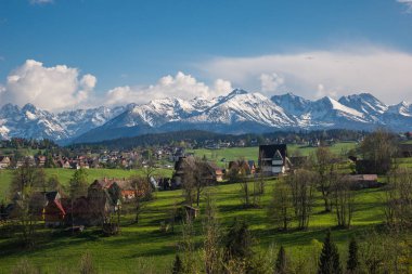 Panorama of snowy Tatra mountains and Podhale village Bukowina T clipart