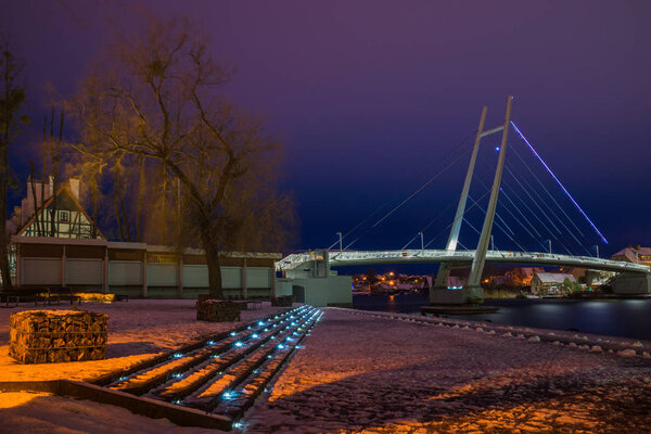 Bridge over the lake in Mikolajki at night, Masuria, Poland