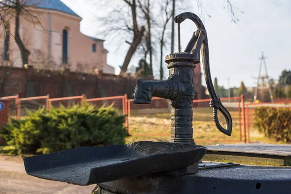 Hand pump for wells near church in Warka, Masovia, Poland