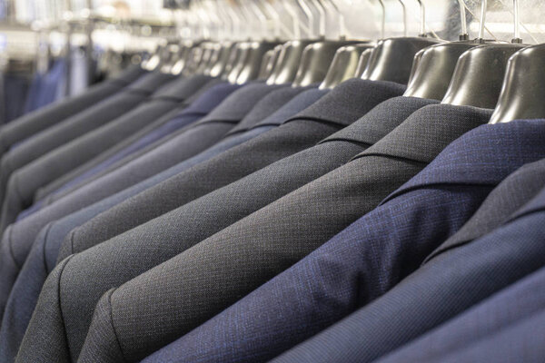 Men's jackets (suits) in blue and gray in a men's clothing store