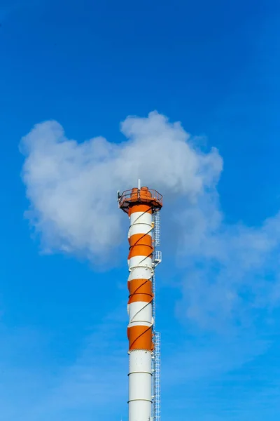 Smoke pollution. Smoke pipes against the blue sky