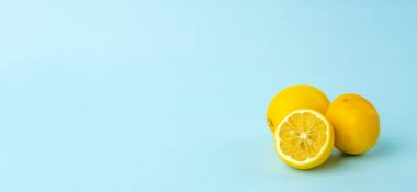 Summer and vitamins background banner. Lemon on a blue backgroun clipart