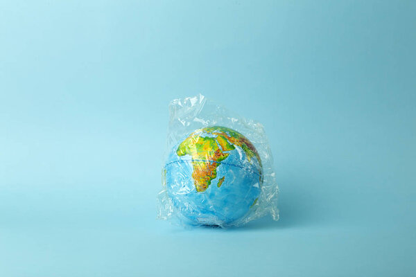 Plastic bag pollution concept. Earth globe in a plastic bag on a