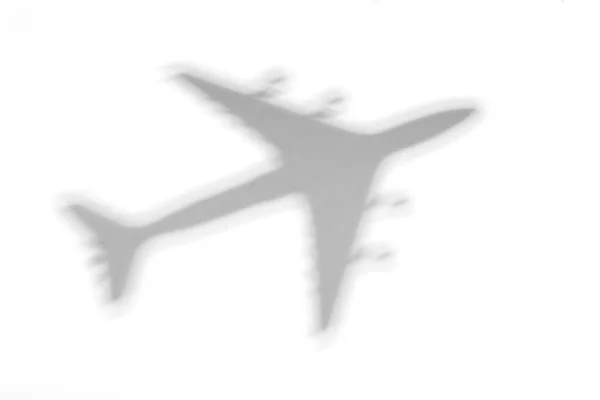 Shadow of an airplane on a white background — Stock Photo, Image