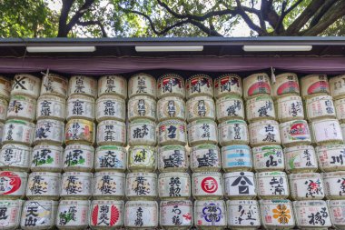 TOKYO, JAPAN - NOVEMBER 04, 2019: Consecrations of Meiji Jingu Shinto shrine, traditional sake wine barrels pattern background in Yoyogi park located at Shibuya, Tokyo.
