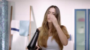 O blow-dried sonra genç çekici kadın güzel saçları ile mutlu.