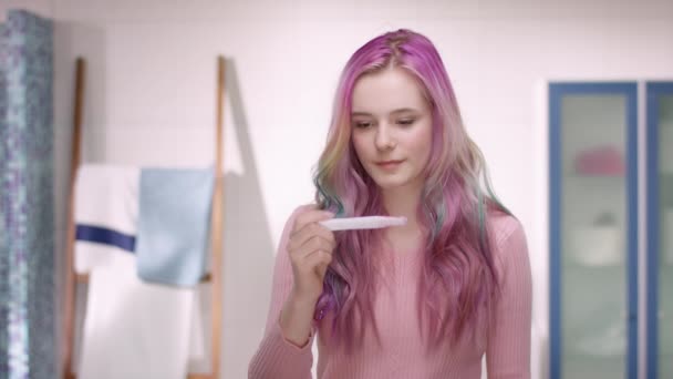 Young woman is very happy about her pregnancy test result — Stock Video