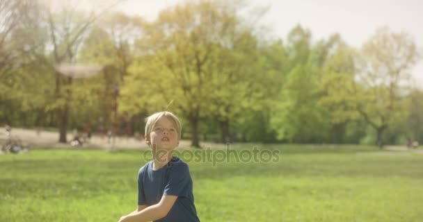 Bonito menino loiro está jogando beisebol com uma vara de madeira fora — Vídeo de Stock