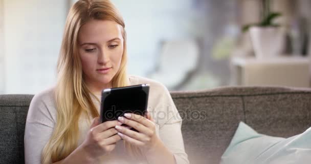 Young woman doing something on a tablet — Stock Video