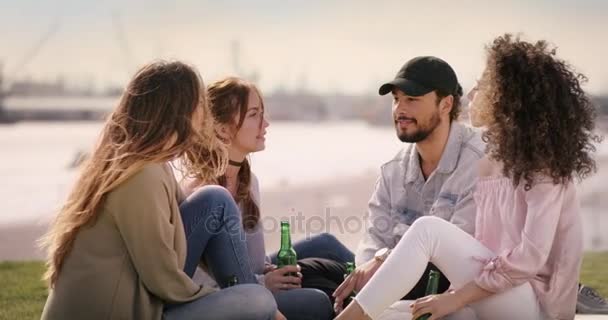 Gyönyörű fiatalok elfogyaszthat egy italt a piknik napján, a városi környezetben — Stock videók