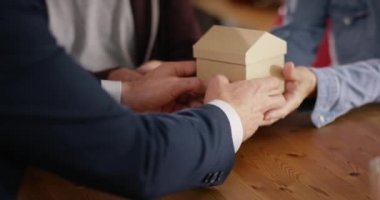 Ellerinde bir sembolü olarak küçük bir ev tutarak Çift
