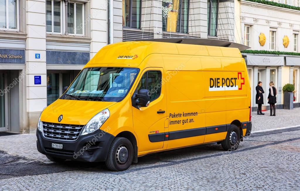 Zurich, Switzerland - 11 December, 2015: a Swiss Post van parked at the entrance to a bank office on Munsterhof square in the old town of the city, two persons standing in the background. Swiss Post is the national postal service of Switzerland.