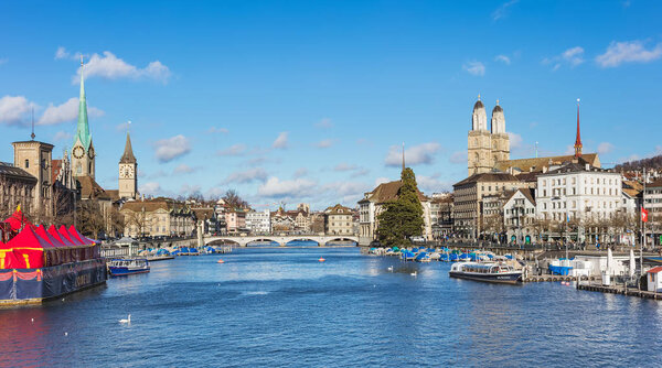 Zurich, Switzerland - 1 January, 2018: view along the Limmat river, towers of the Fraumunster and Grossmunster cathedrals. Zurich is the largest city in Switzerland and the capital of the Swiss canton of Zurich.