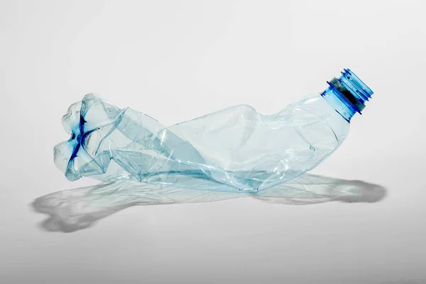 Crumpled plastic bottle on a light background. The concept of ecology — Stock Photo, Image