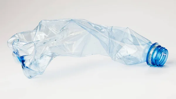 Crumpled plastic bottle on a light background. The concept of ecology — Stock Photo, Image