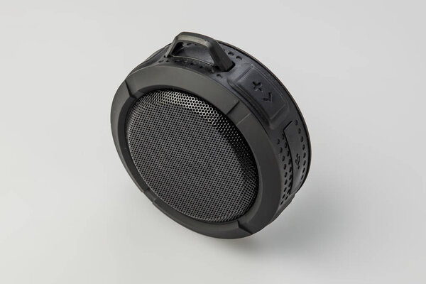 Round Bluetooth speaker on white background isolate